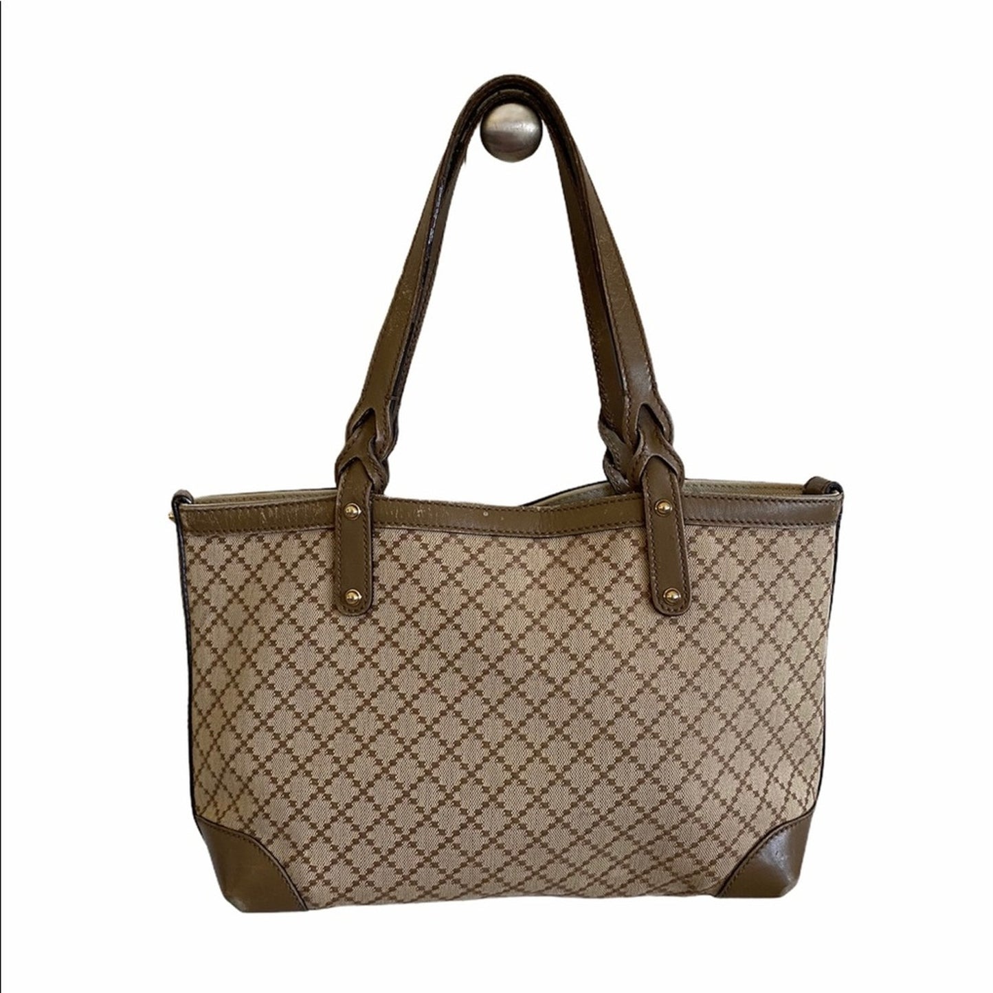 Back of Beige handbag with brown accents on a white background