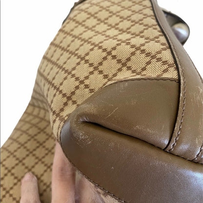 Close-up of corners a brown handbag with a checkered pattern