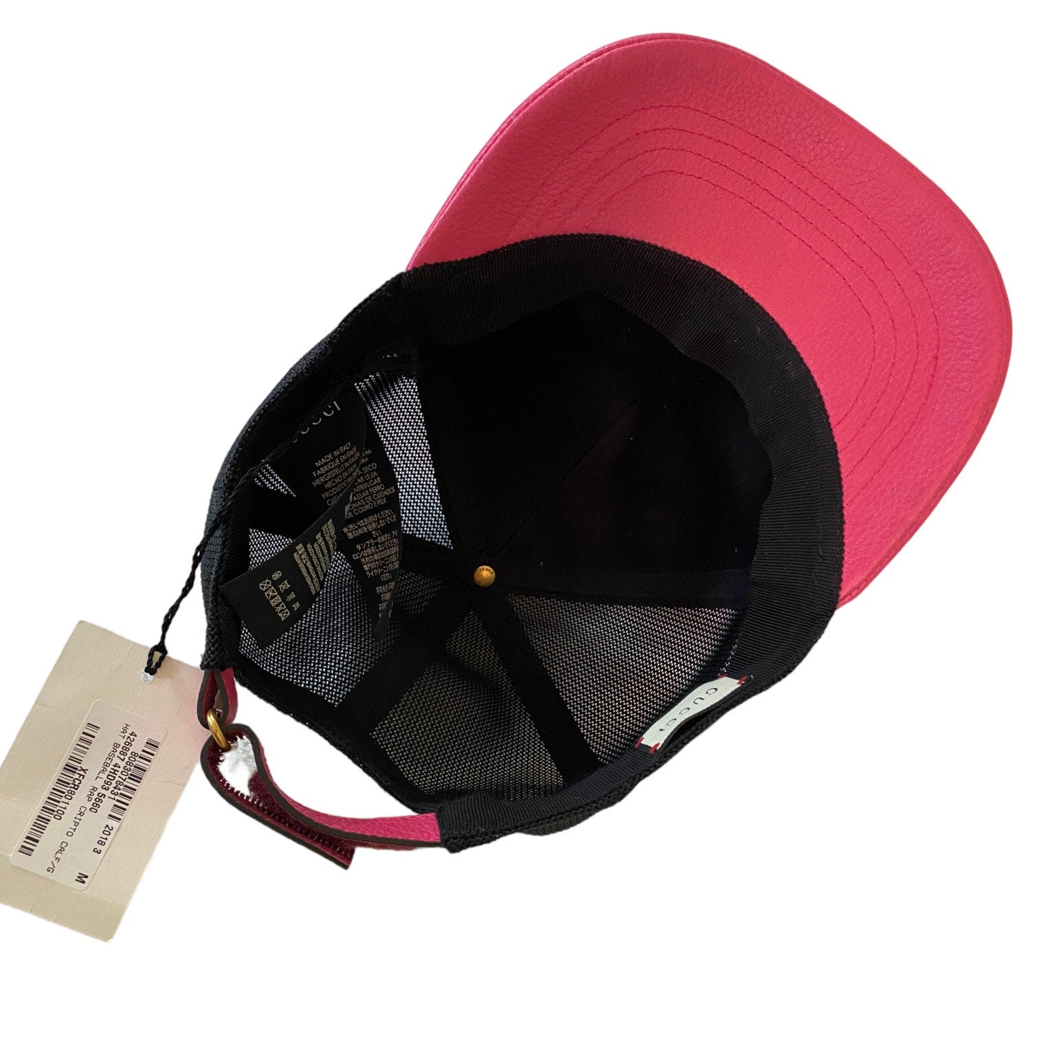 Pink and black cap with a tag on a white background