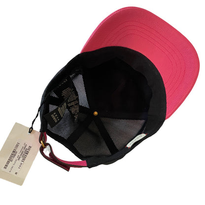Pink and black cap with a tag on a white background