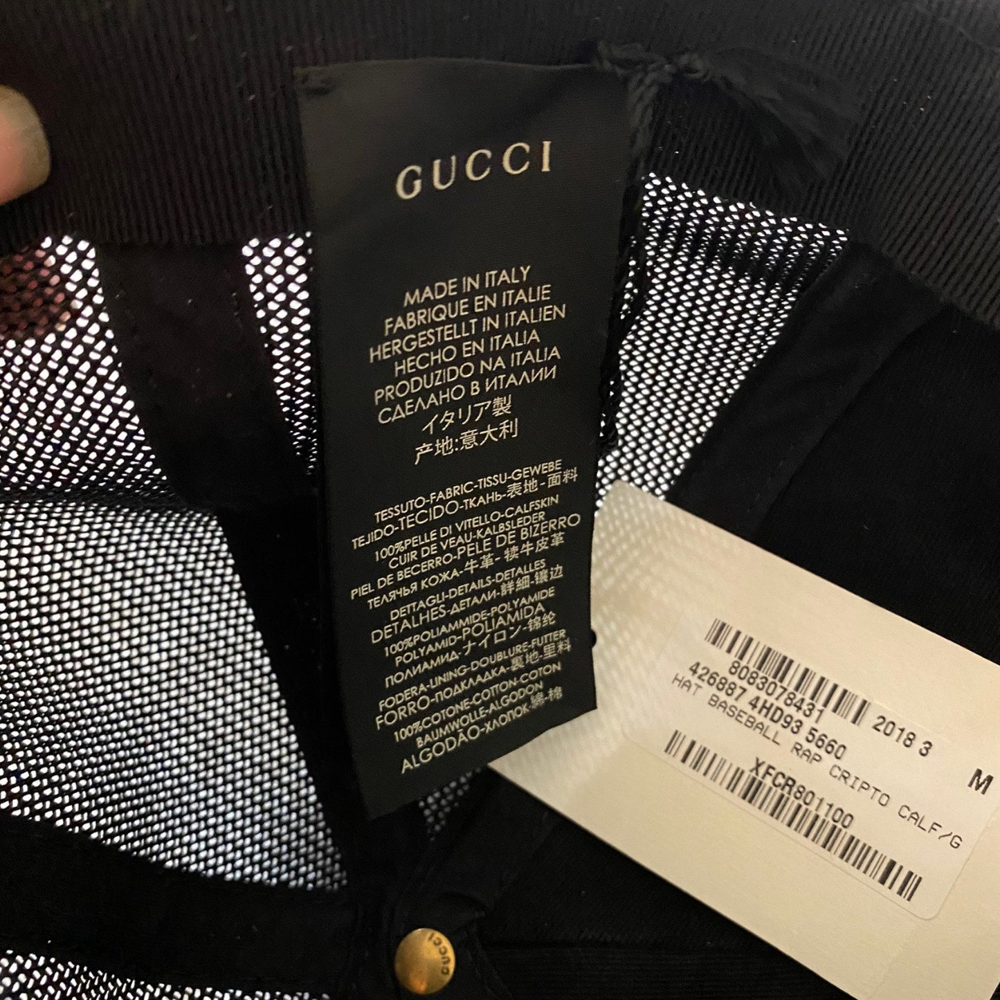 Gucci label on a garment with text and barcode