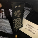 Gucci label on a garment with text and barcode