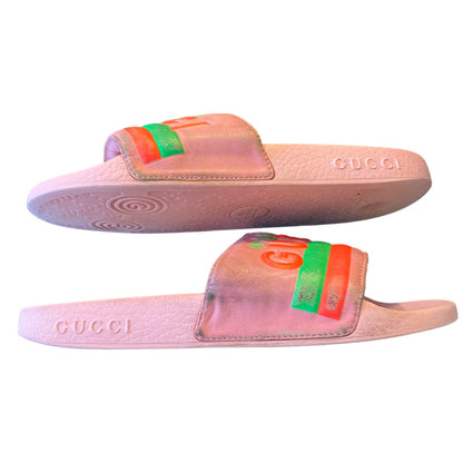 Pink Gucci slides with colorful stripes on a white background on their side 5