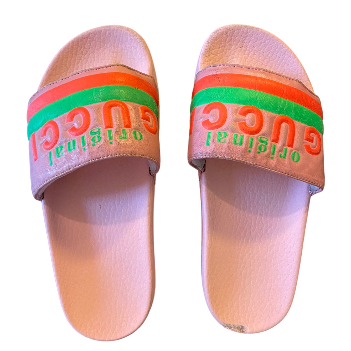 Pair of slides with colorful strap and visible branding on a white background