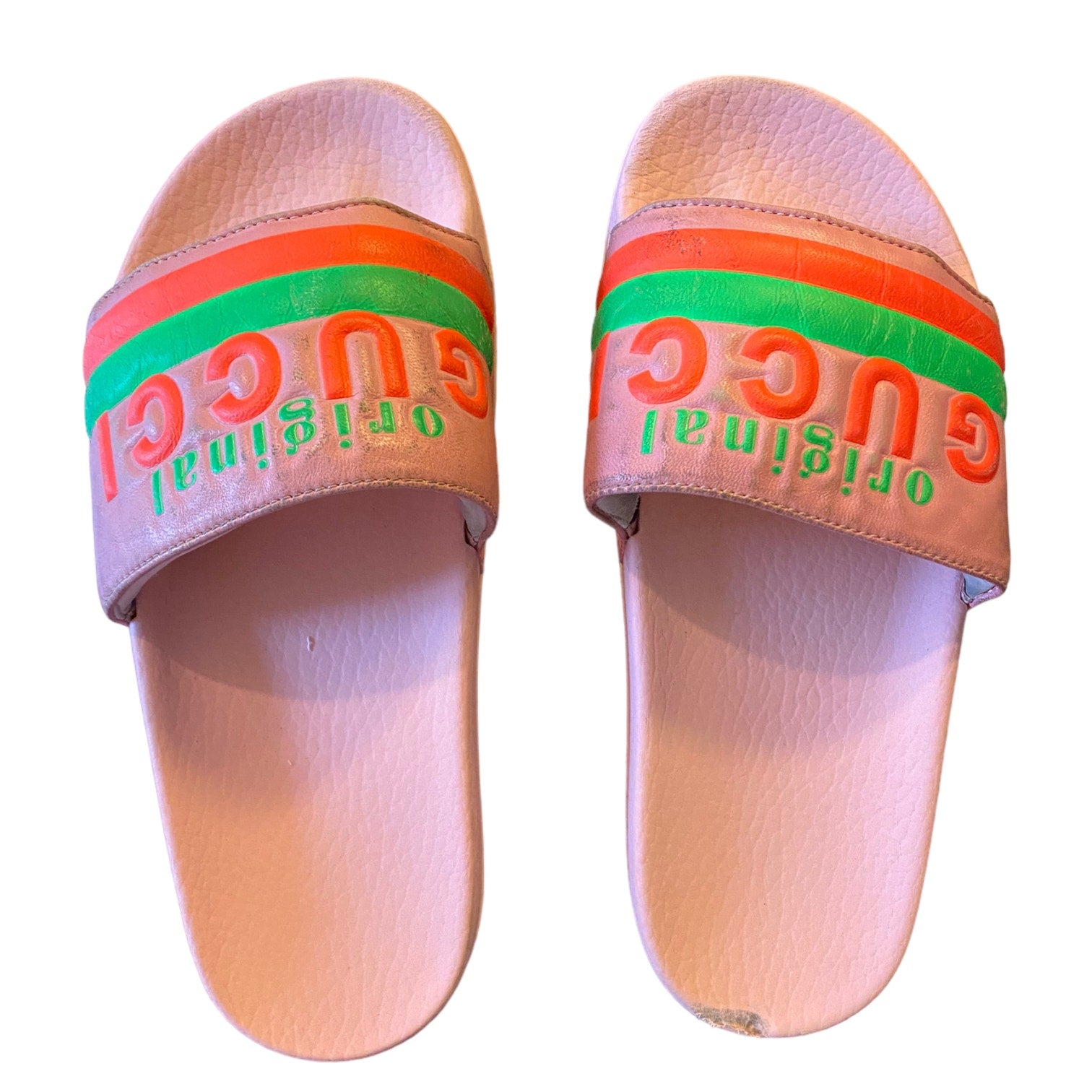 Pair of slides with colorful strap and visible branding on a white background