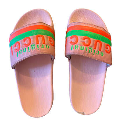 Pair of slides with colorful strap and visible branding on a white background