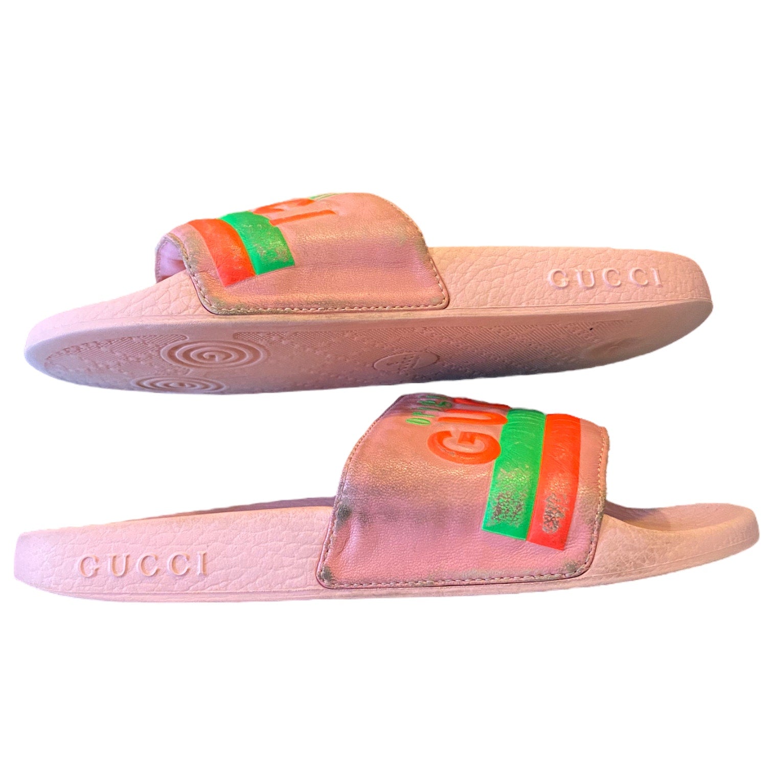 Pink Gucci slides with green and orange accents on a white background on their side 4
