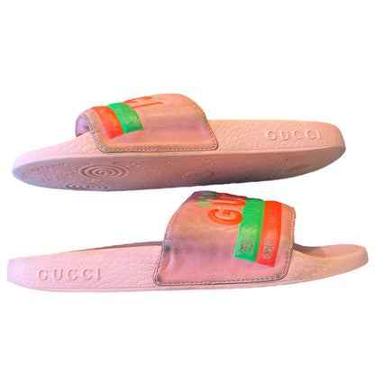 Pink Gucci slides with green and orange accents on a white background on their side 4