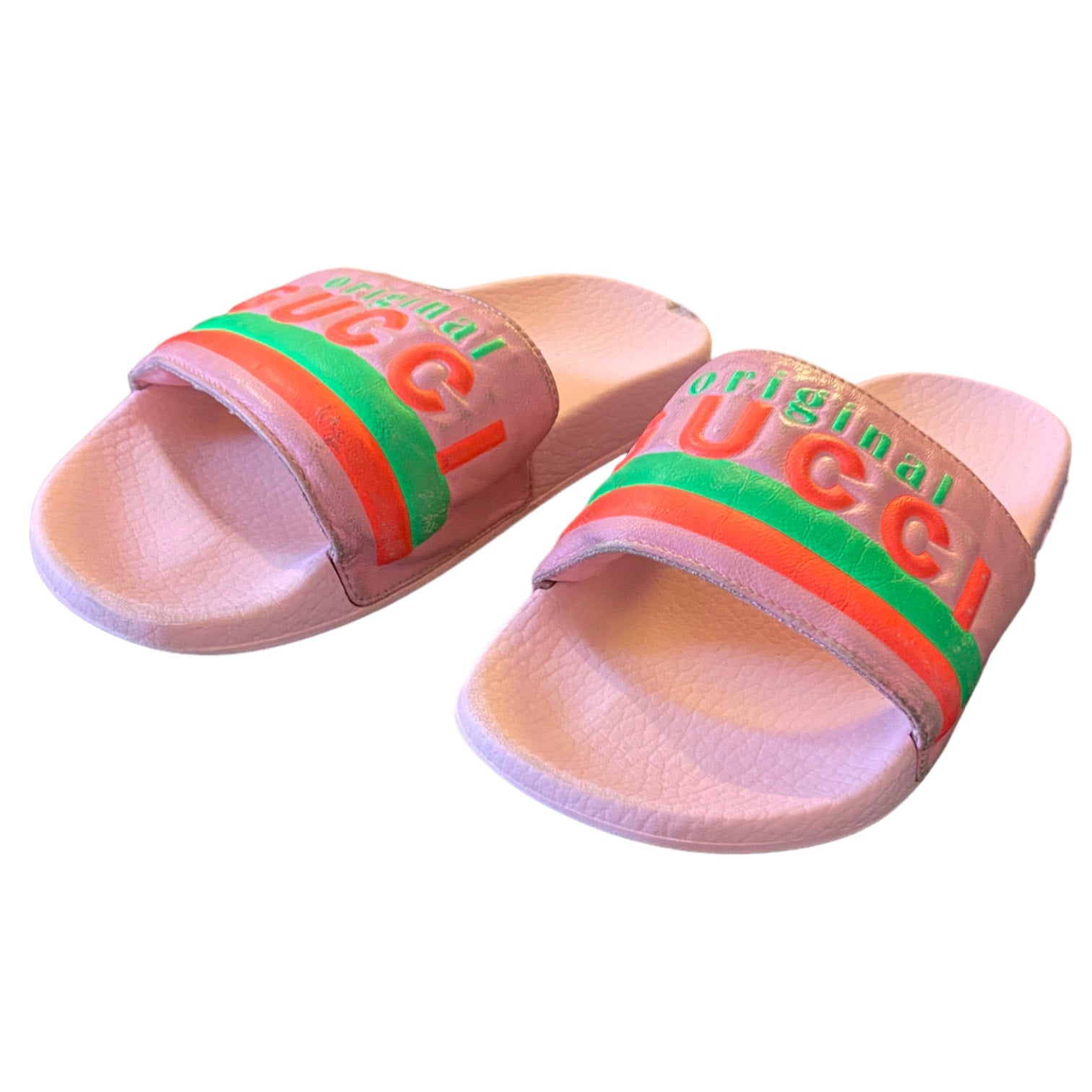 Pink slides with Gucci logo on a white background
