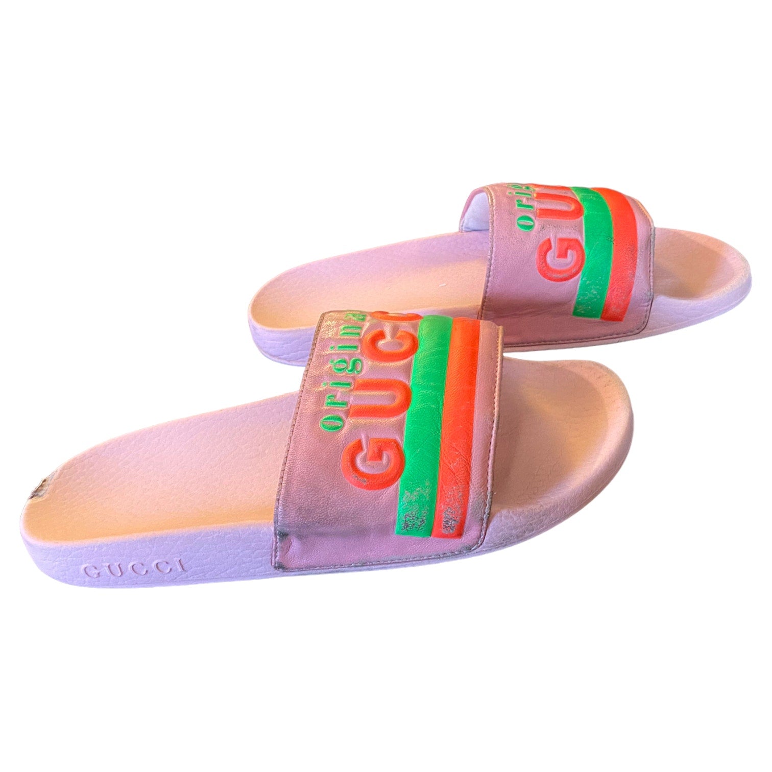 Pink slide sandals with colorful Gucci logo on a white background side view 1