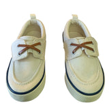 Front of a Pair of off white children's shoes with brown laces on a white background