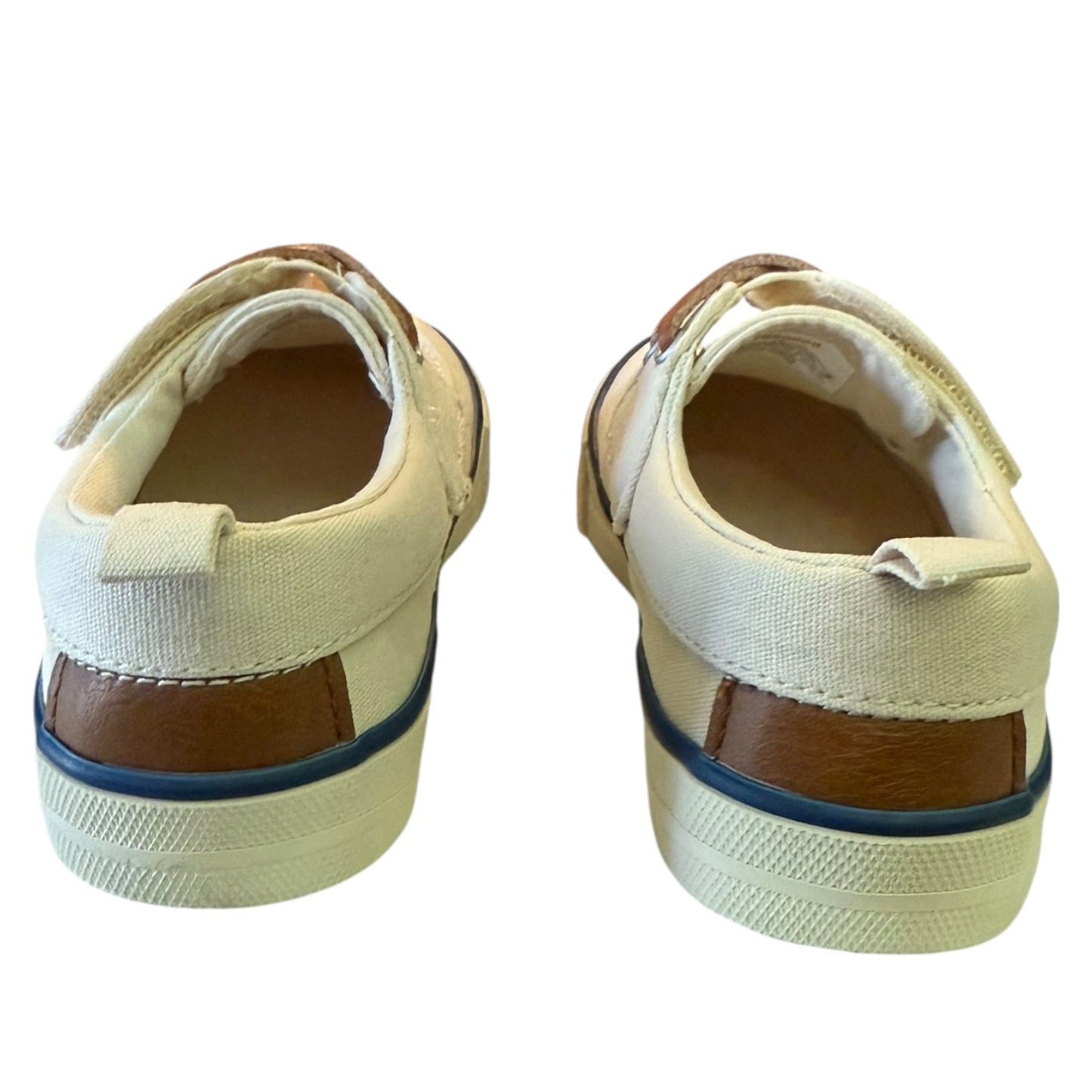 Back of a Pair of children's shoes with brown soles on a white background