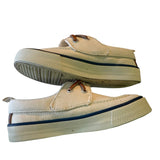 Side view of casual shoes with brown laces on a white background