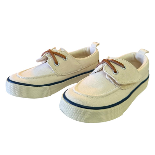 Pair of off white boat shoes with brown laces on a white background