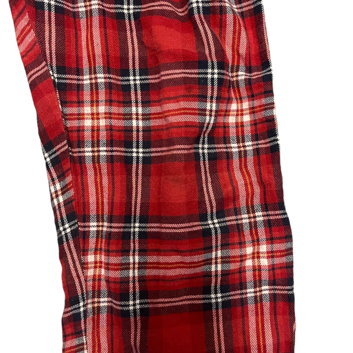 Red and black plaid fabric with a mark  on a white background