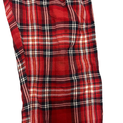 Red and black plaid fabric with a mark  on a white background