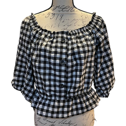 A black and white gingham blouse displayed on a vintage-style mannequin torso against a plain white background.