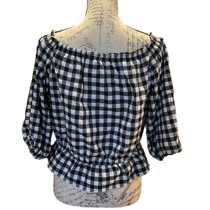A black and white gingham check blouse displayed on a vintage-style dress form mannequin against a plain white background.