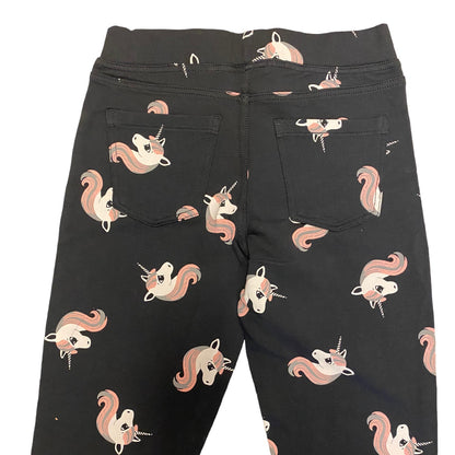 Close up on dark gray jeggings with unicorns showing pockets on a white background
