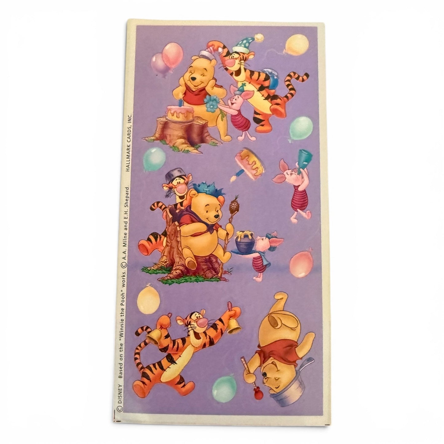Sheet of Winnie the Pooh and friends stickers on a purple background