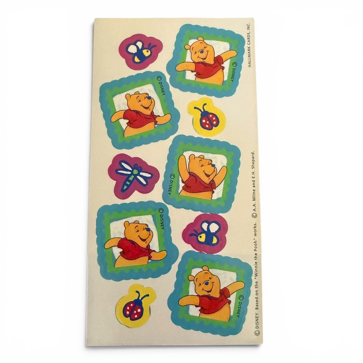 Sheet of Winnie the Pooh stickers on a beige background
