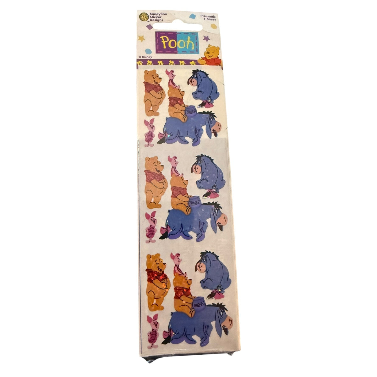 A packaged sheet of Winnie the Pooh sticker characters, featuring Pooh, Piglet, Eeyore, and  on a white backing with a colorful header card.