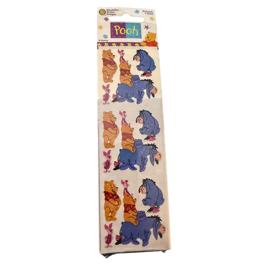 A packaged sheet of Winnie the Pooh sticker characters, featuring Pooh, Piglet, Eeyore, and  on a white backing with a colorful header card.