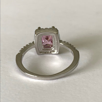 Back of Silver ring with a pink gemstone on a white background