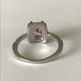 Back of Silver ring with a pink gemstone on a white background