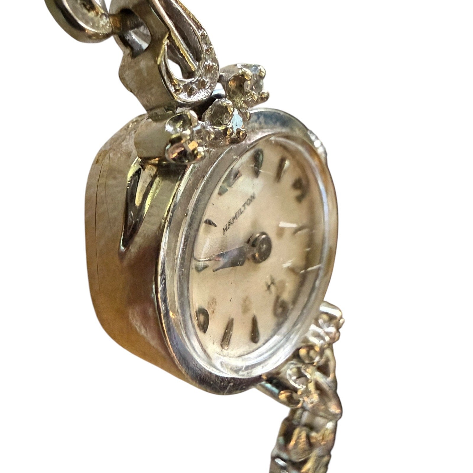Vintage silver watch with decorative chain on a white background