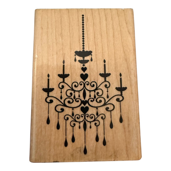 Wooden block with a black chandelier design on a white background