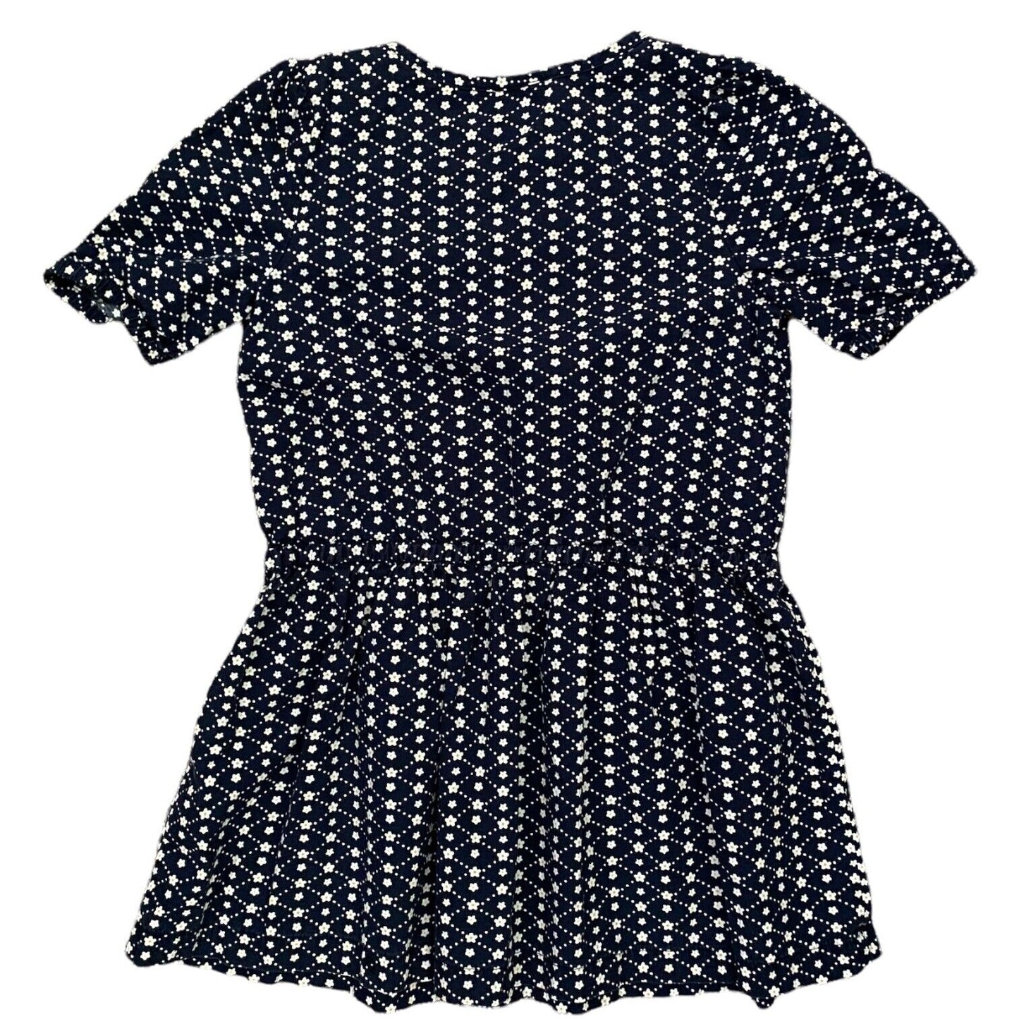 A short-sleeve peplum dress with an all-over white ditsy floral print on a dark navy blue background, shown flat against a white background.