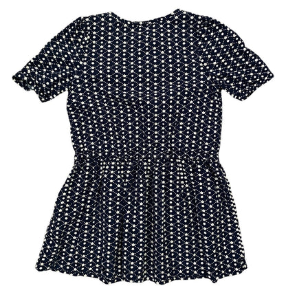 A short-sleeve peplum dress with an all-over white ditsy floral print on a dark navy blue background, shown flat against a white background.