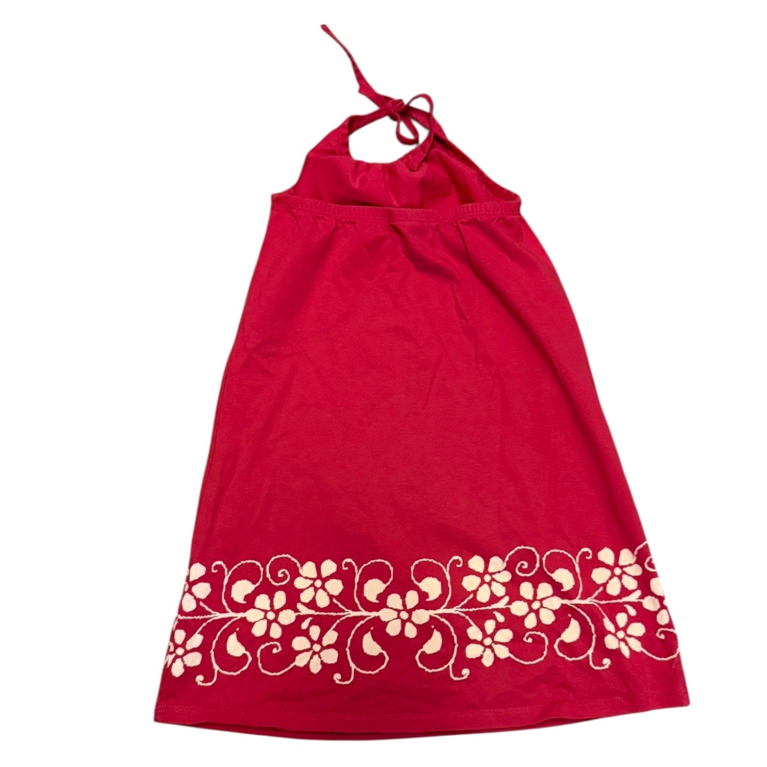 Back of pink dress with white floral design on a white background