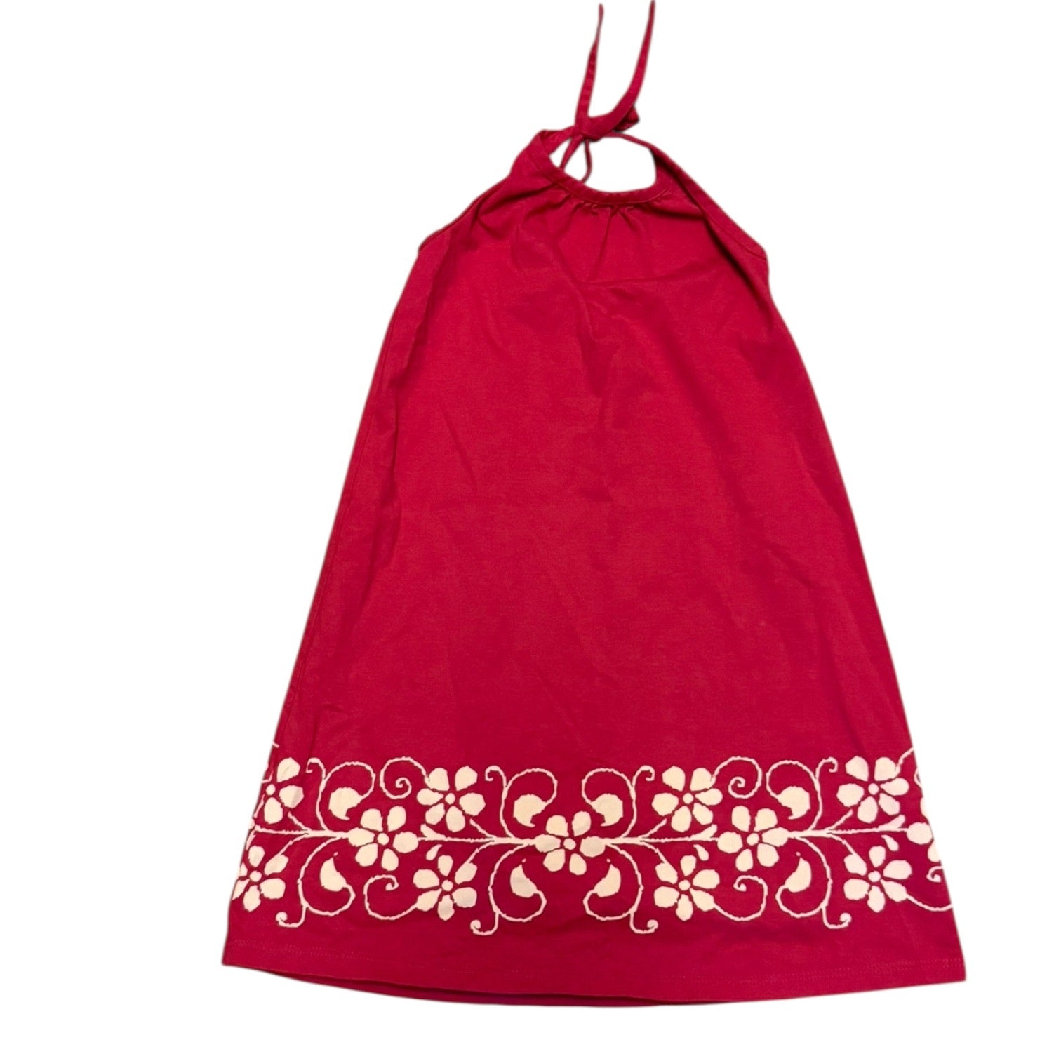 Pink dress with white floral design on a white background