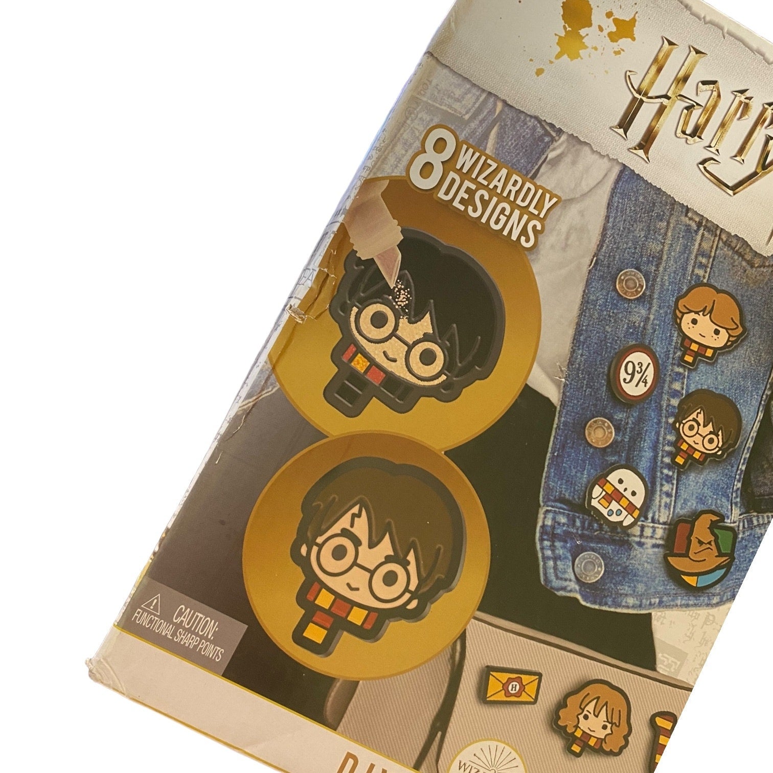 Pack of Harry Potter-themed pins with packaging showing designs and branding with damage to the box