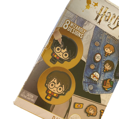 Pack of Harry Potter-themed pins with packaging showing designs and branding with damage to the box