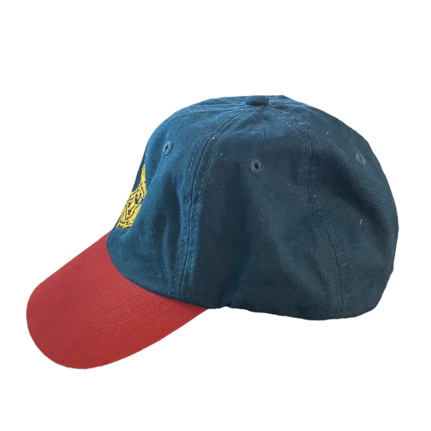 A baseball cap with a dark blue crown and a red curved brim, featuring a small yellow embroidered logo on the front.