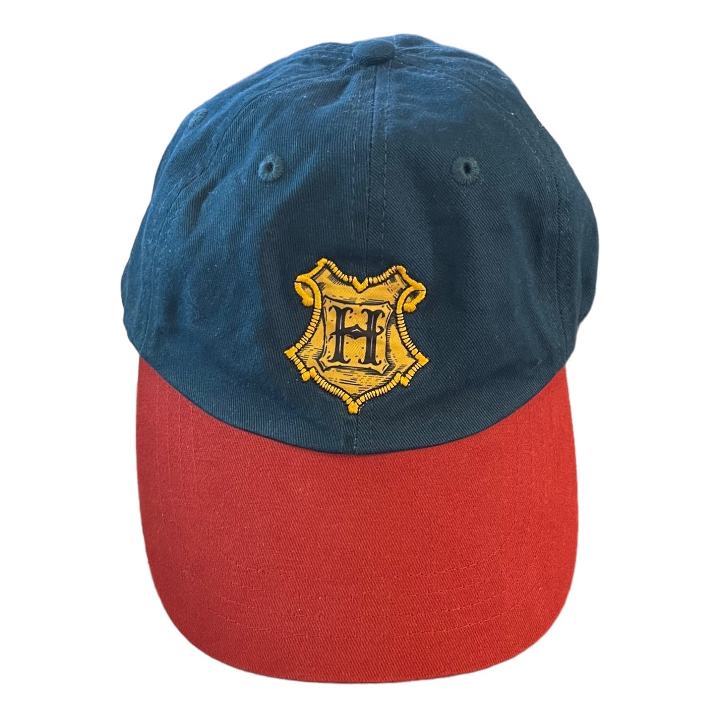 A two-tone baseball cap with a dark blue crown and a red curved brim, featuring a gold embroidered crest with the letters 'H' on the front.