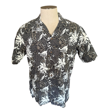 A men's short-sleeve button-up shirt displayed on a mannequin torso. The shirt features a  gray base with a bold white floral and vine pattern.