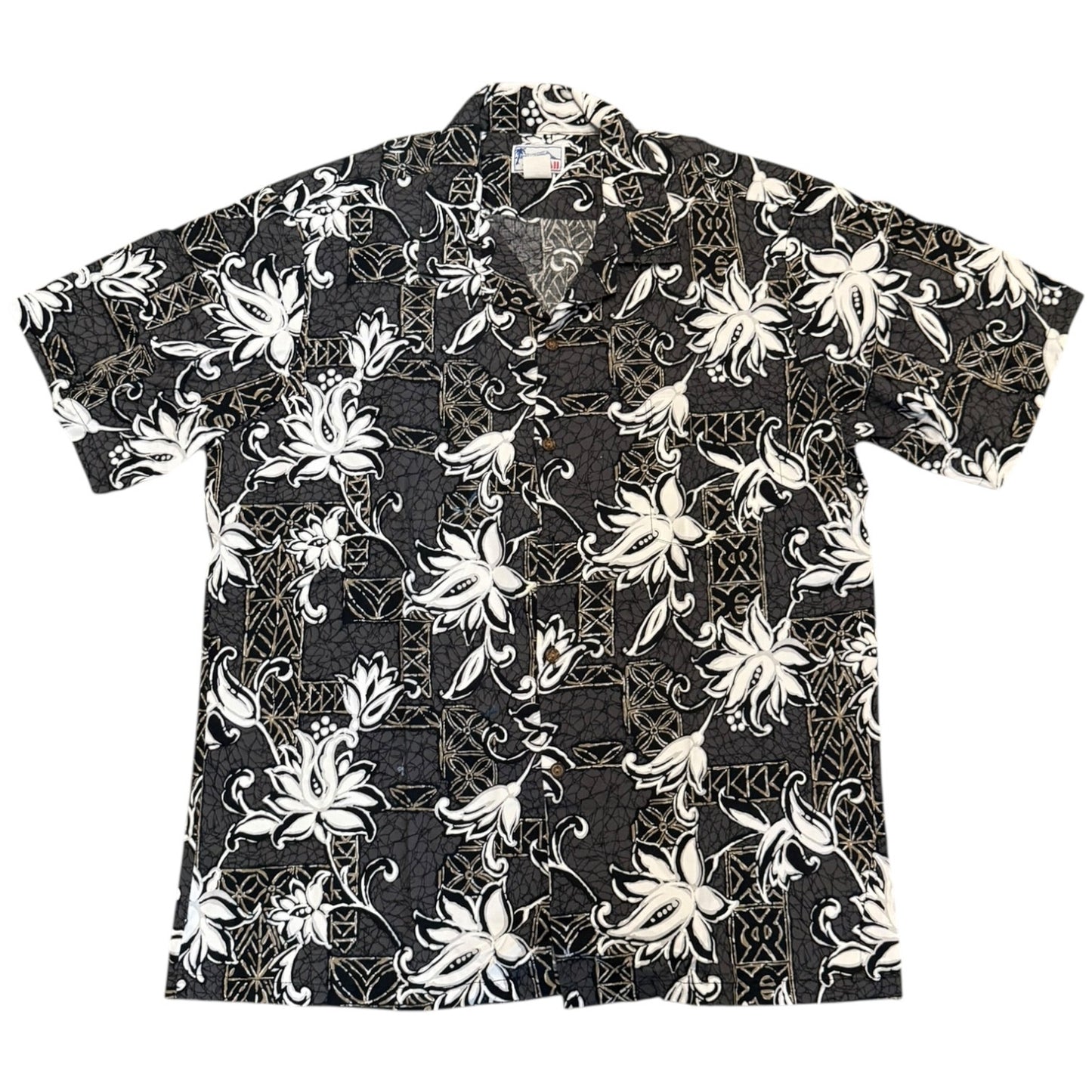 A short-sleeve button-up aloha shirt with a gray base featuring a white floral and vine pattern, laid flat against a white background.
