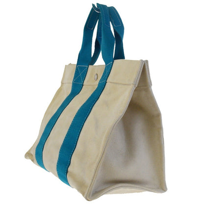White tote bag with blue handles on a white background