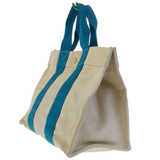 White tote bag with blue handles on a white background