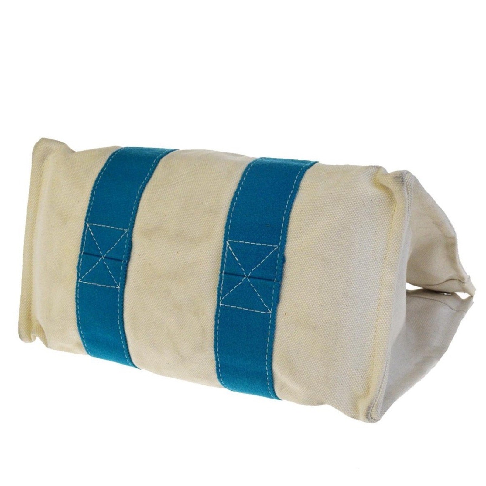 Bottom of white bag with a blue strap on a white background