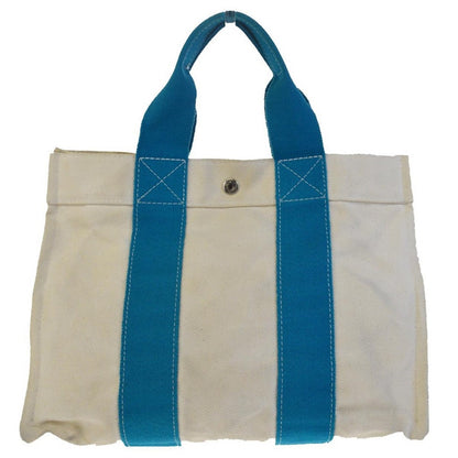 White tote bag with blue handles on a white background