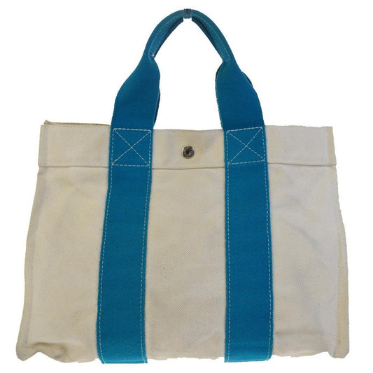 White tote bag with blue handles on a white background