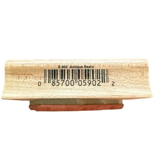 A close-up of a wooden stamp block with a barcode printed on its face and a reddish-brown rubber stamp foot visible underneath, isolated on a white background.