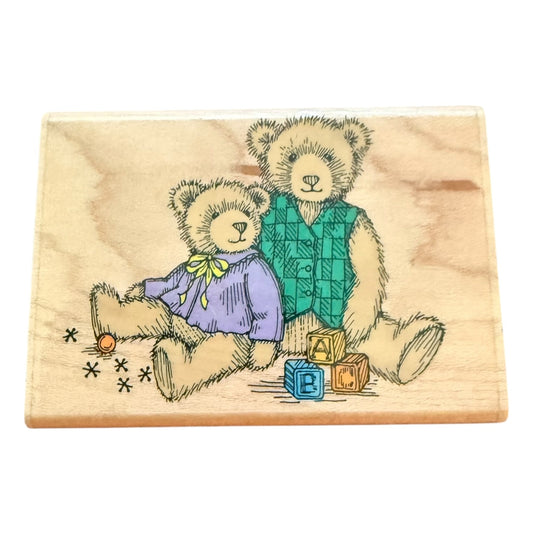 Wooden stamp with two teddy bears and blocks on a white background