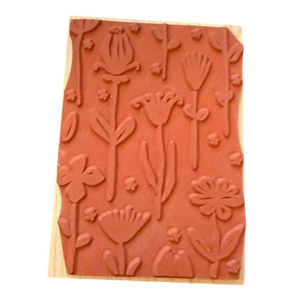 Wooden stamp block with floral embossing on a white background