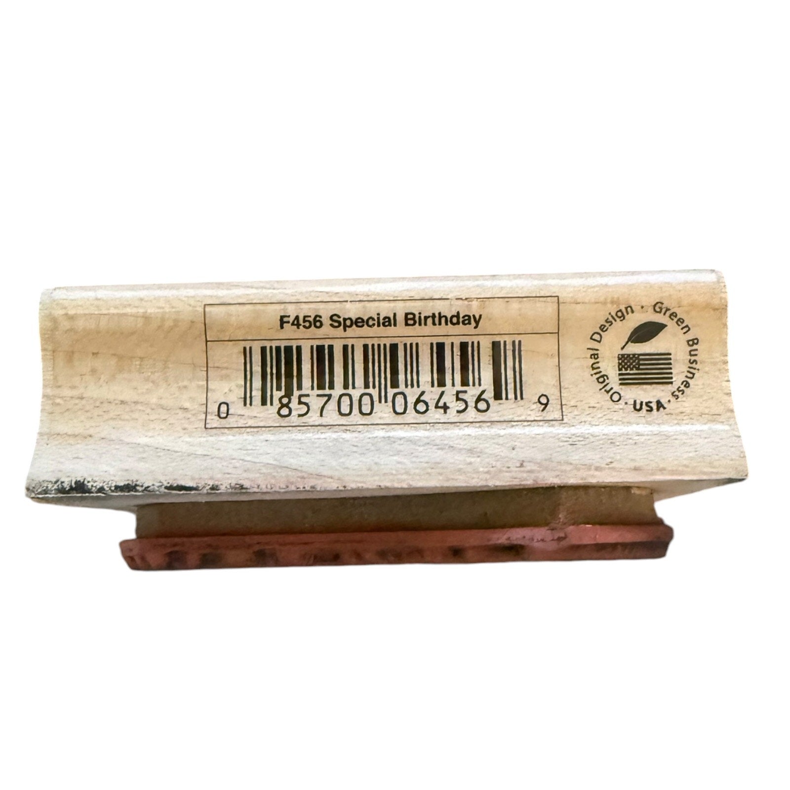 A wooden rubber stamp block with a printed barcode and text reading 'F456 Special Birthday' on the top, shown against a plain white background.